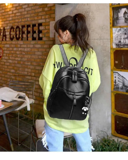 Black PU leather backpack with double straps showing ID compartment and zipper opening