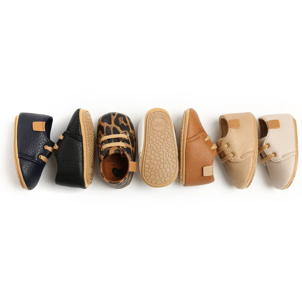 Soft leather baby moccasins with anti-slip rubber soles in beige colour showing low height design
