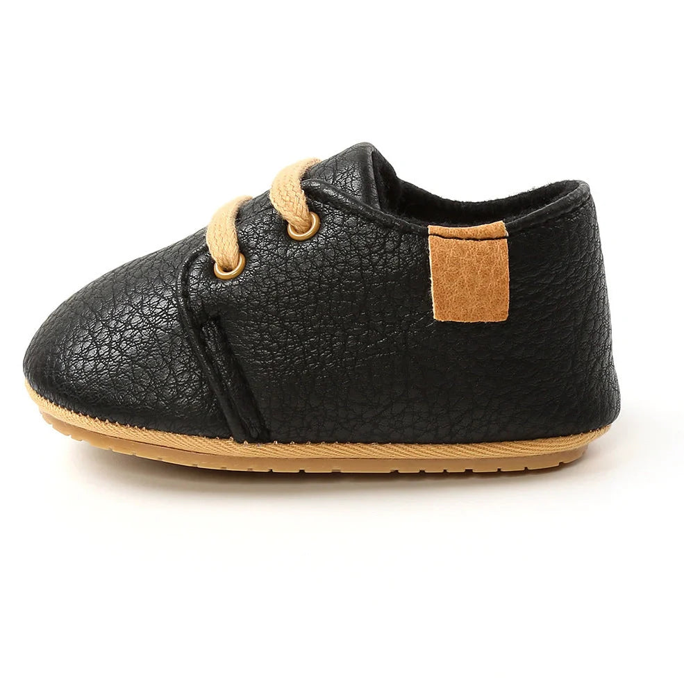 Soft leather baby moccasins with anti-slip rubber soles in beige colour showing low height design