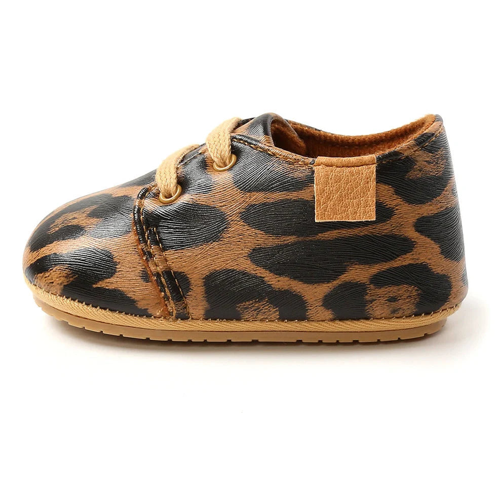 Soft leather baby moccasins with anti-slip rubber soles in beige colour showing low height design