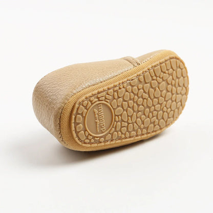 Soft leather baby moccasins with anti-slip rubber soles in beige colour showing low height design
