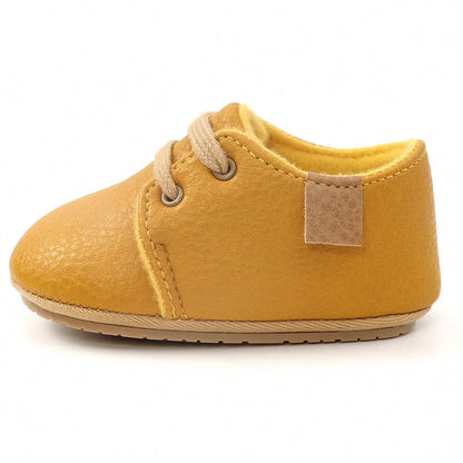 Soft leather baby moccasins with anti-slip rubber soles in beige colour showing low height design