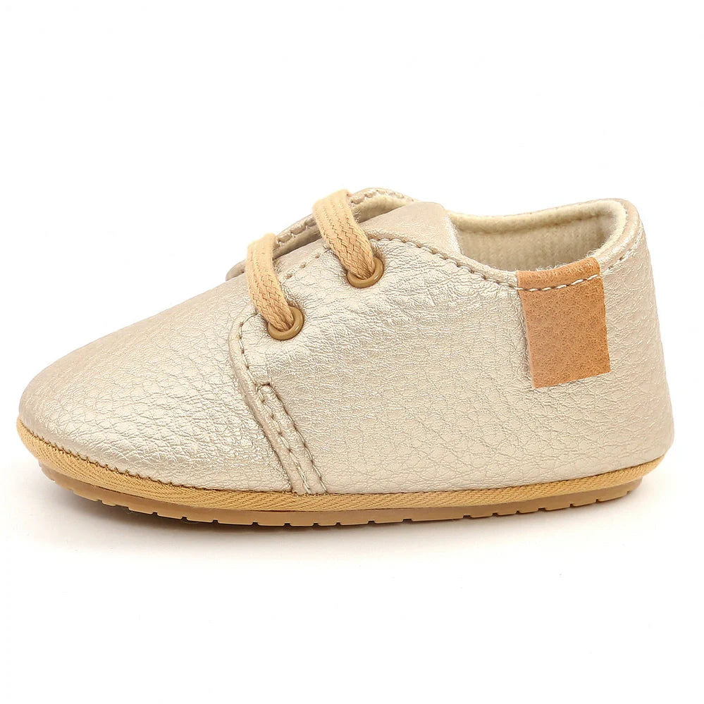 Soft leather baby moccasins with anti-slip rubber soles in beige colour showing low height design