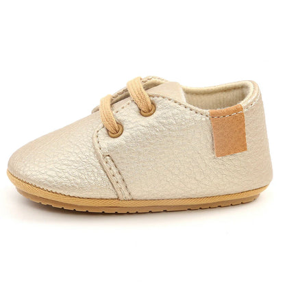 Soft leather baby moccasins with anti-slip rubber soles in beige colour showing low height design
