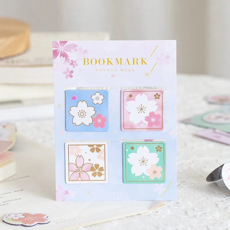 Set of four sakura-themed magnetic bookmarks showing cherry blossom designs on stone paper