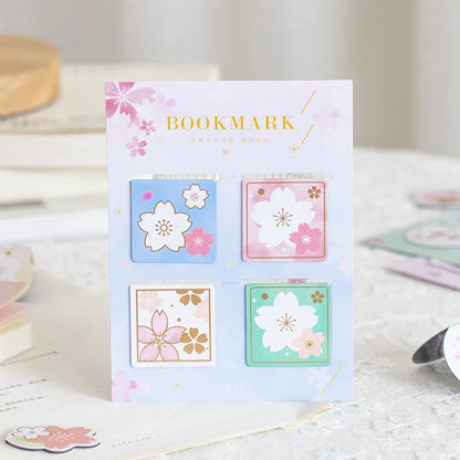 Set of four sakura-themed magnetic bookmarks showing cherry blossom designs on stone paper
