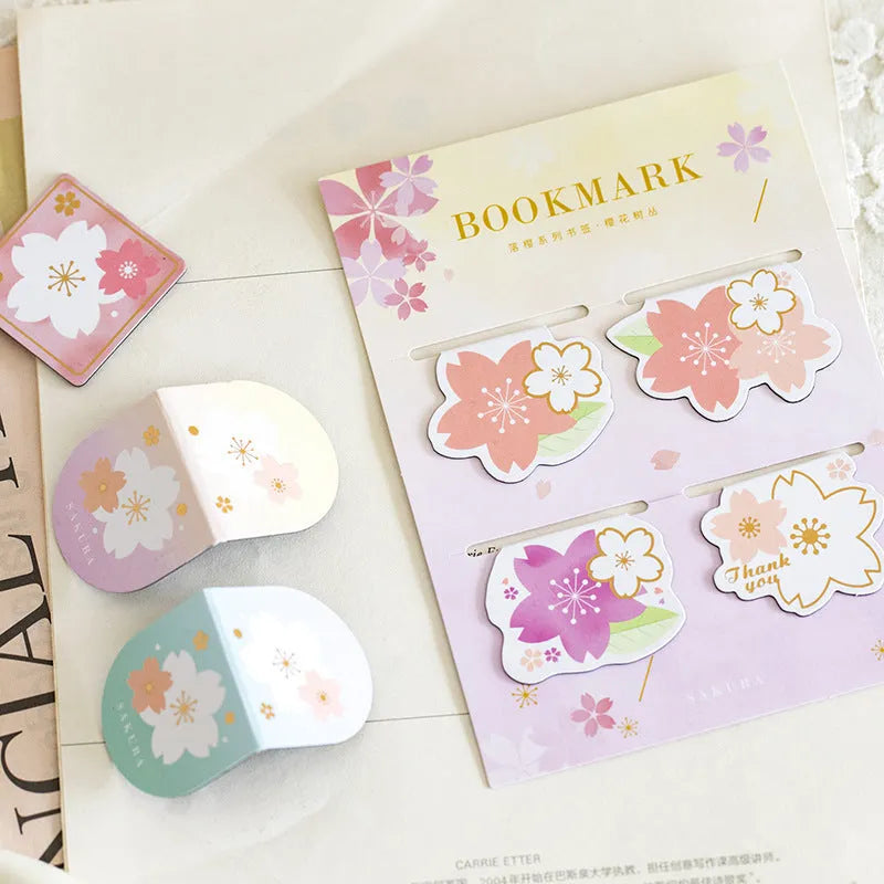 Set of four sakura-themed magnetic bookmarks showing cherry blossom designs on stone paper