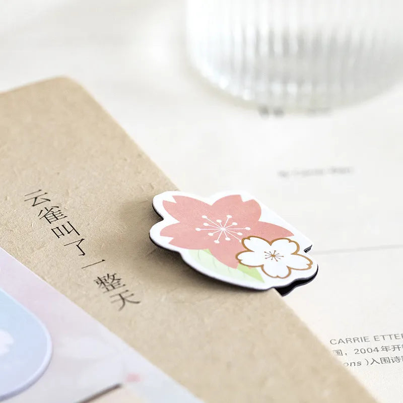 Set of four sakura-themed magnetic bookmarks showing cherry blossom designs on stone paper