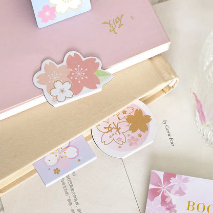 Set of four sakura-themed magnetic bookmarks showing cherry blossom designs on stone paper