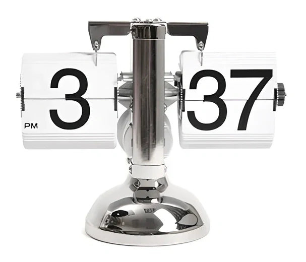 Black and white flip digital clock showing 12:34 with retro flip digits on wooden table