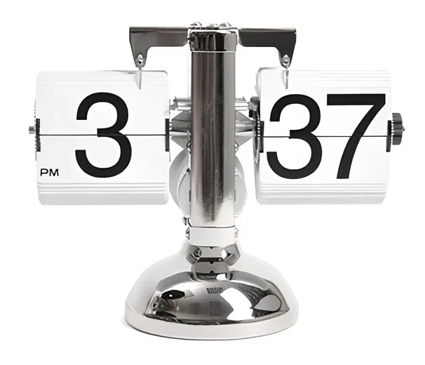 Black and white flip digital clock showing 12:34 with retro flip digits on wooden table