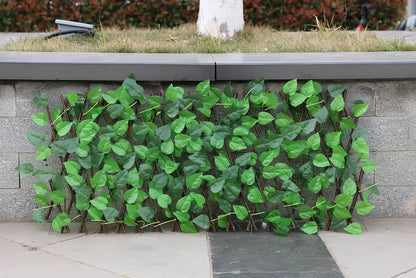 Simulation wooden garden fence with telescopic sections expanded to 60cm width beside flowering plants