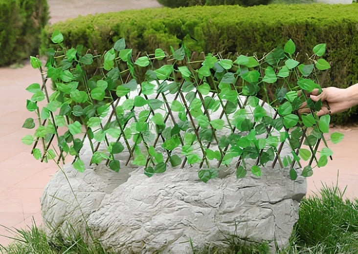 Simulation wooden garden fence with telescopic sections expanded to 60cm width beside flowering plants