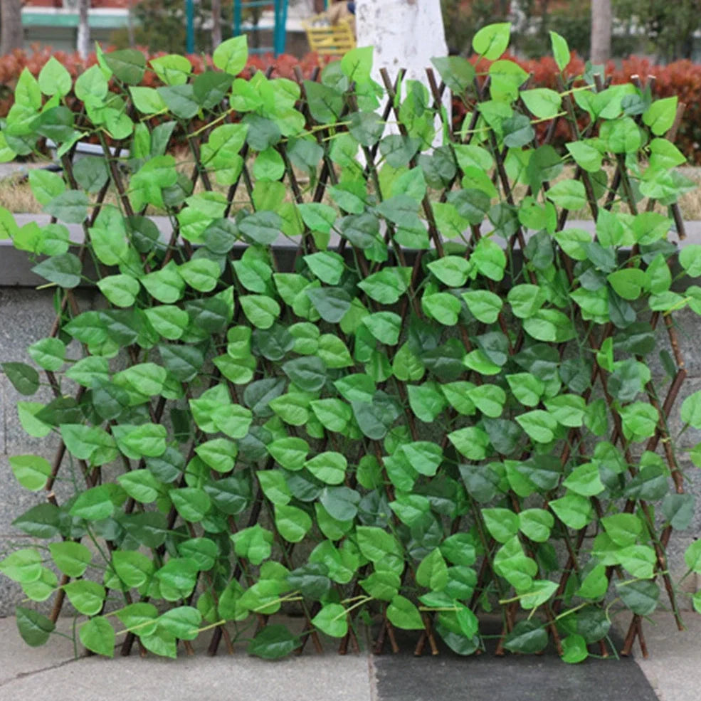 Simulation wooden garden fence with telescopic sections expanded to 60cm width beside flowering plants