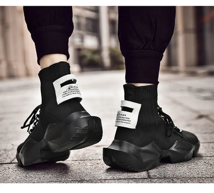 Men's black and white socks-style casual sports shoes with mesh lining, shown in large sizes.
