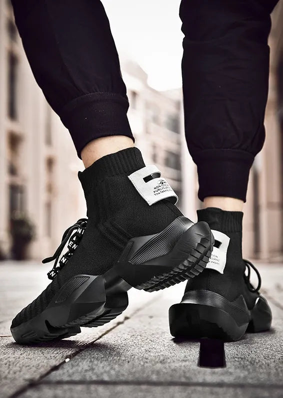 Men's black and white socks-style casual sports shoes with mesh lining, shown in large sizes.