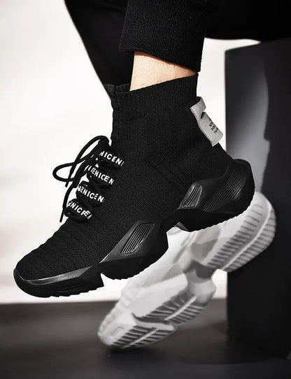 Men's black and white socks-style casual sports shoes with mesh lining, shown in large sizes.