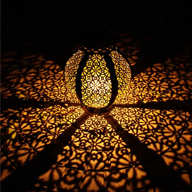 Black six-sided solar garden hanging lamp with wrought iron frame and clear glass panels