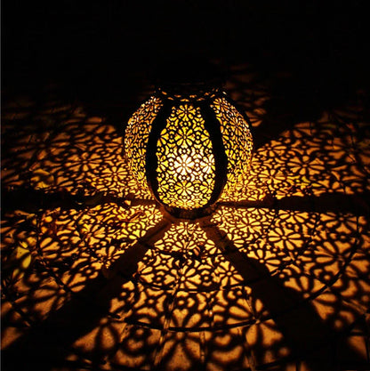 Black six-sided solar garden hanging lamp with wrought iron frame and clear glass panels