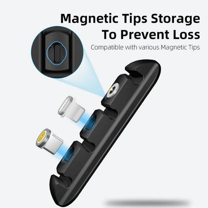 Black soft plastic magnetic data cable organizer on a desktop, holding charging cables neatly in place