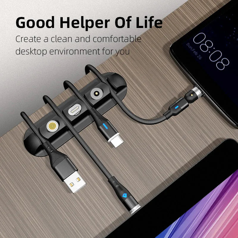 Black soft plastic magnetic data cable organizer on a desktop, holding charging cables neatly in place