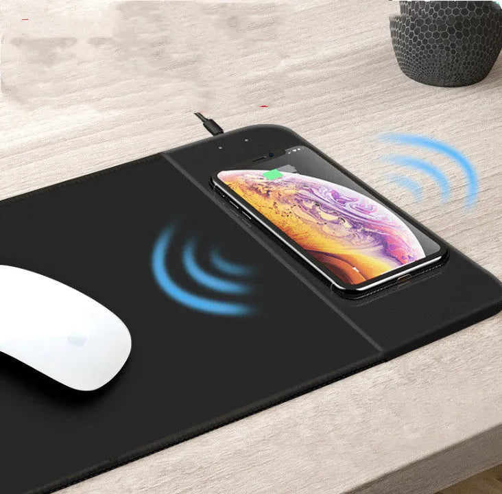 Wireless charging mouse pad showing 298x215mm surface with smartphone charging on integrated Qi pad