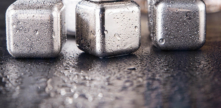 Stainless steel ice cubes in gold and silver finishes with tongs for chilling drinks without dilution