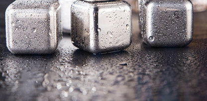 Stainless steel ice cubes in gold and silver finishes with tongs for chilling drinks without dilution