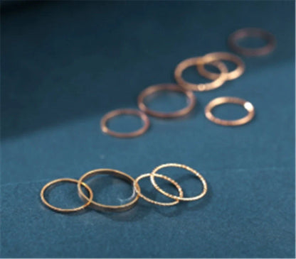 A 10-piece set of bohemian-inspired silver rings with a sleek, geometric design for a stylish, layered look