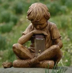 Brown natural resin tabletop ornament with little boy design from The Boy In The Garden