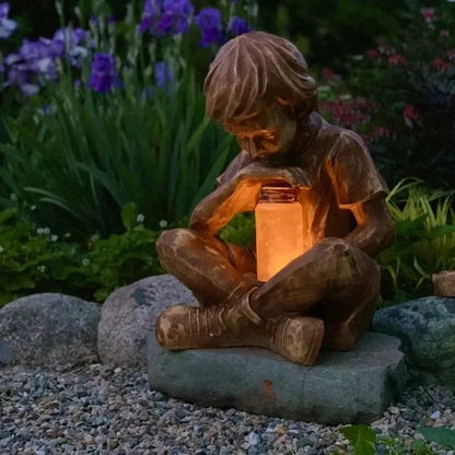 Brown natural resin tabletop ornament with little boy design from The Boy In The Garden
