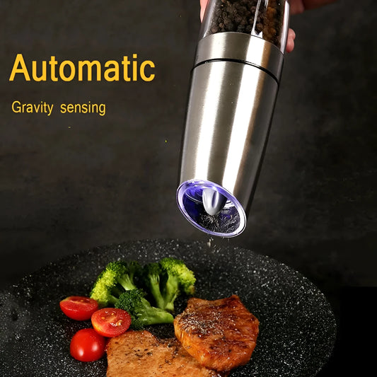 Modern electric gravity pepper grinder in matte black with adjustable ceramic mill and blue LED light on.