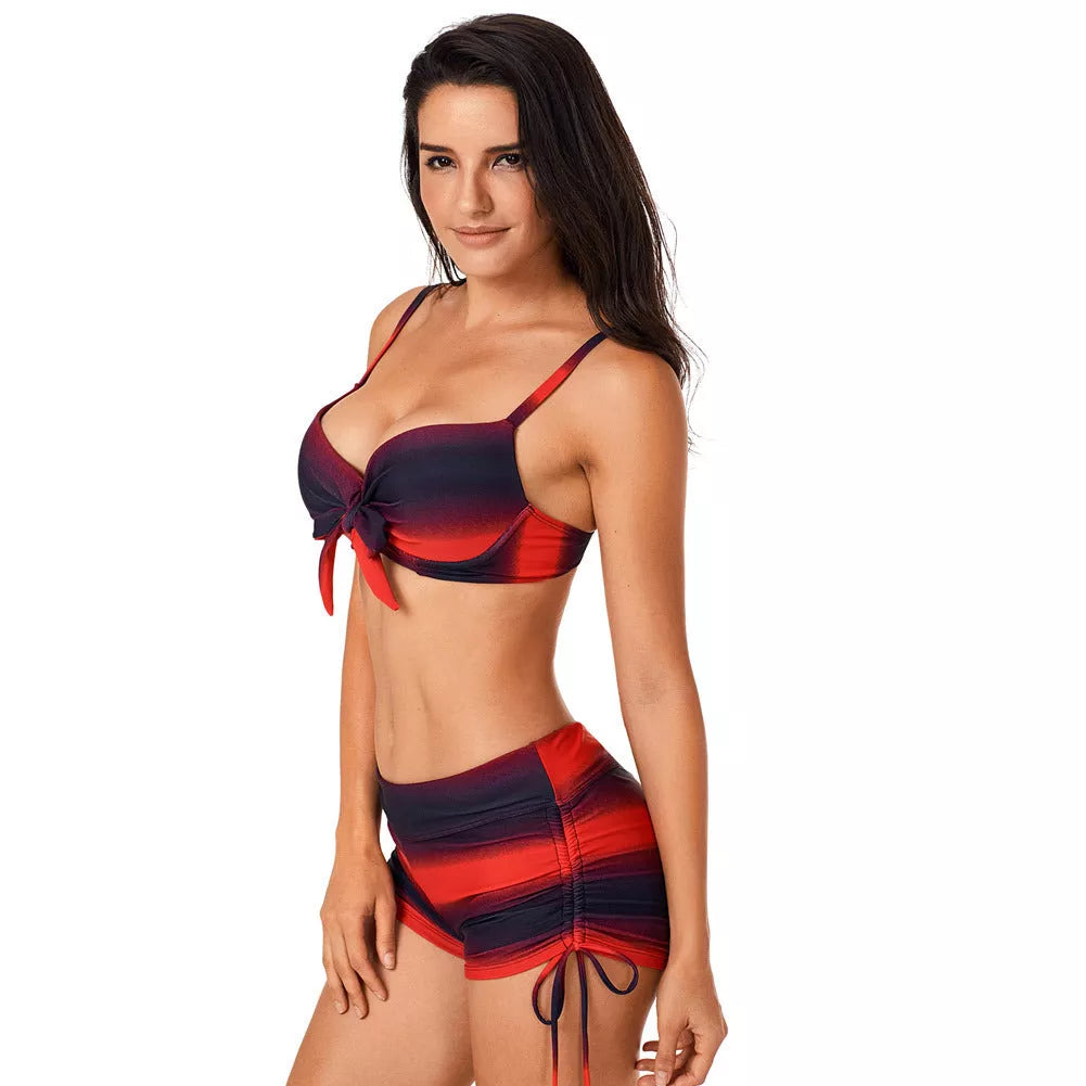 Plus size swimsuit with adjustable fit and gradient pattern in red and blue