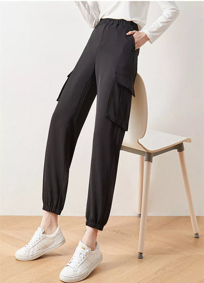 Women's elastic high waist cargo pants in black with multiple pockets