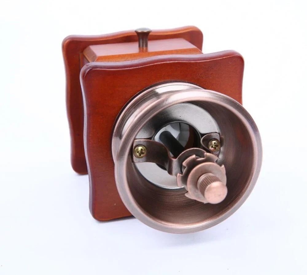 Red manual coffee grinder with pine wood housing and ceramic burrs measuring 10x10x17cm