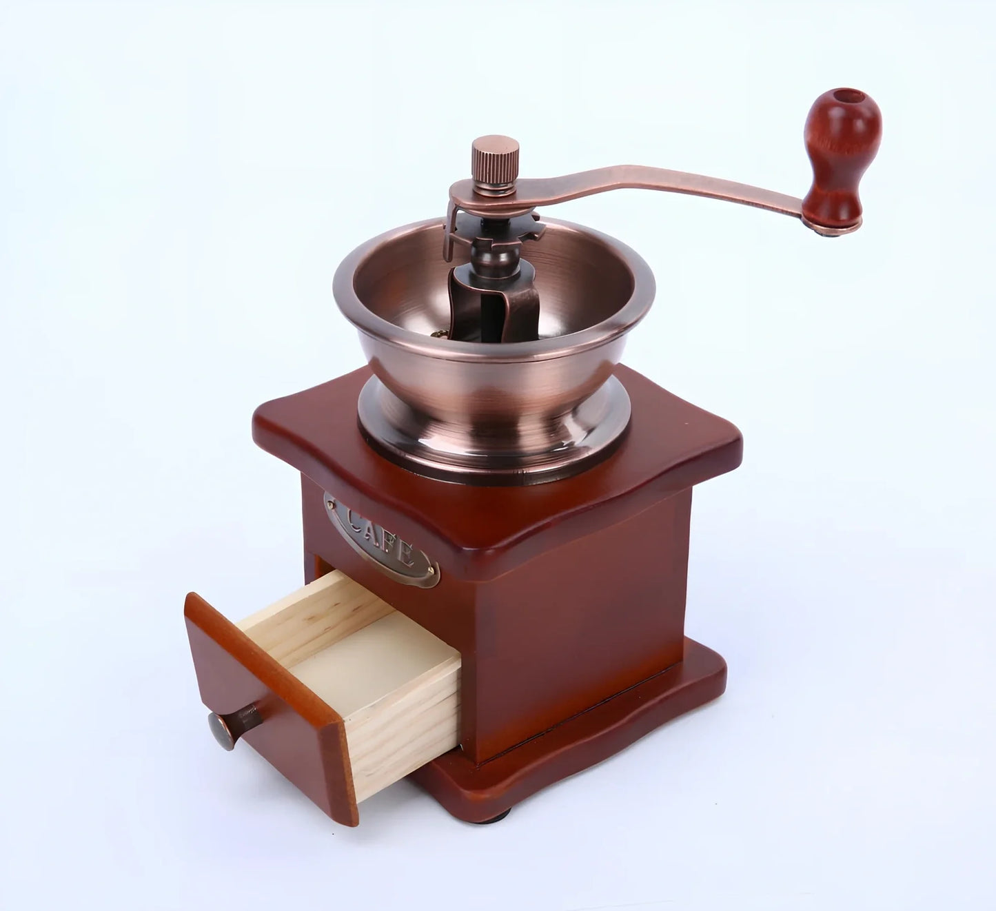 Red manual coffee grinder with pine wood housing and ceramic burrs measuring 10x10x17cm