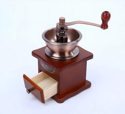 Red manual coffee grinder with pine wood housing and ceramic burrs measuring 10x10x17cm