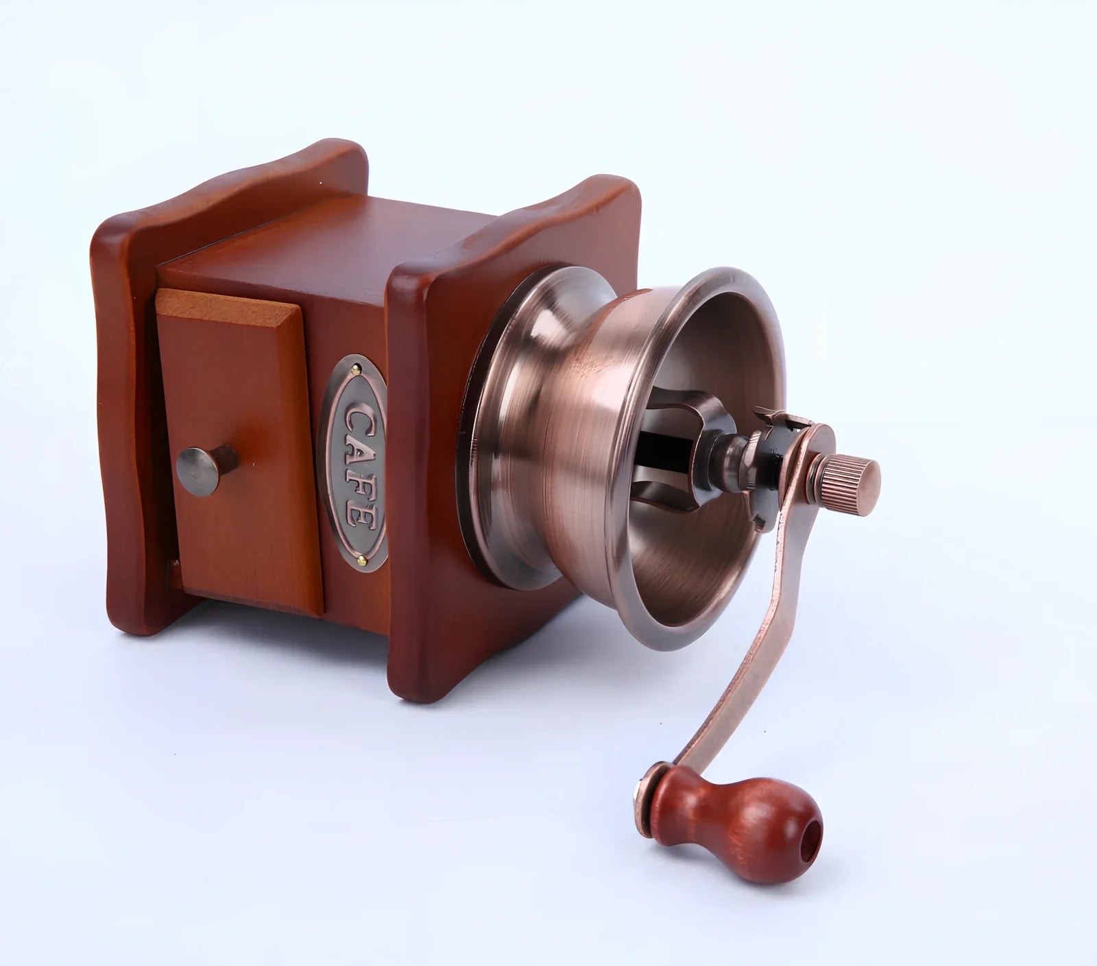 Red manual coffee grinder with pine wood housing and ceramic burrs measuring 10x10x17cm