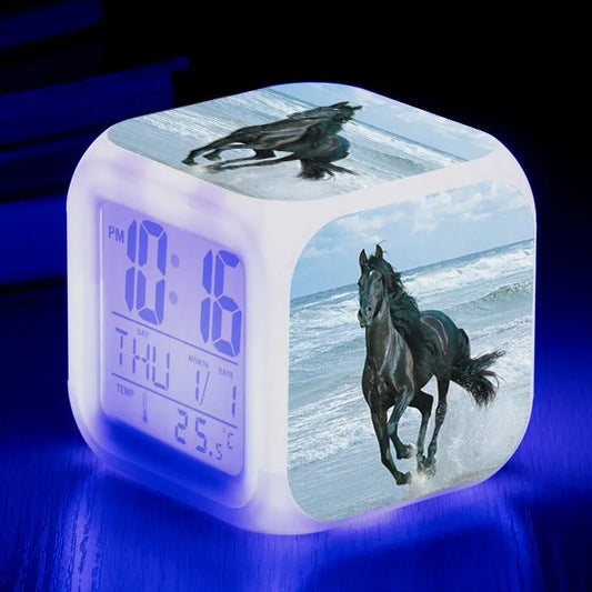 Square creative alarm clock showing LED time display, thermometer reading, and colour-changing design on bedside table