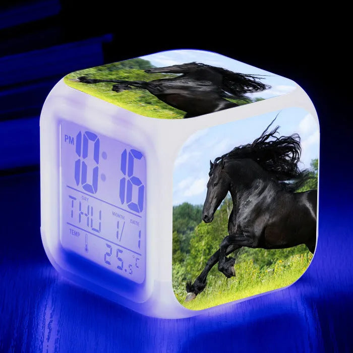 Square creative alarm clock showing LED time display, thermometer reading, and colour-changing design on bedside table