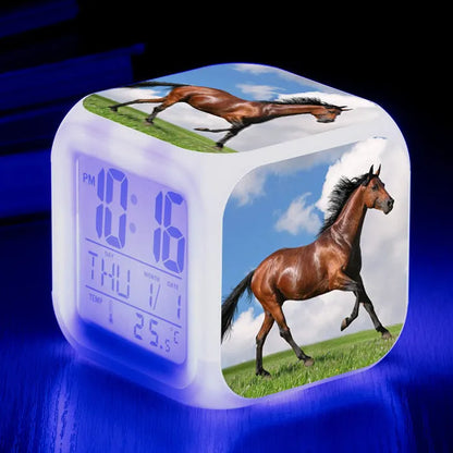 Square creative alarm clock showing LED time display, thermometer reading, and colour-changing design on bedside table