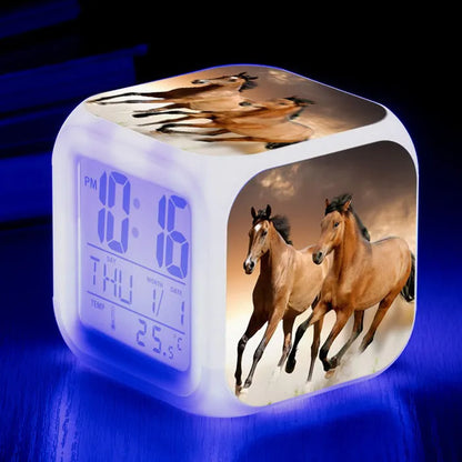 Square creative alarm clock showing LED time display, thermometer reading, and colour-changing design on bedside table