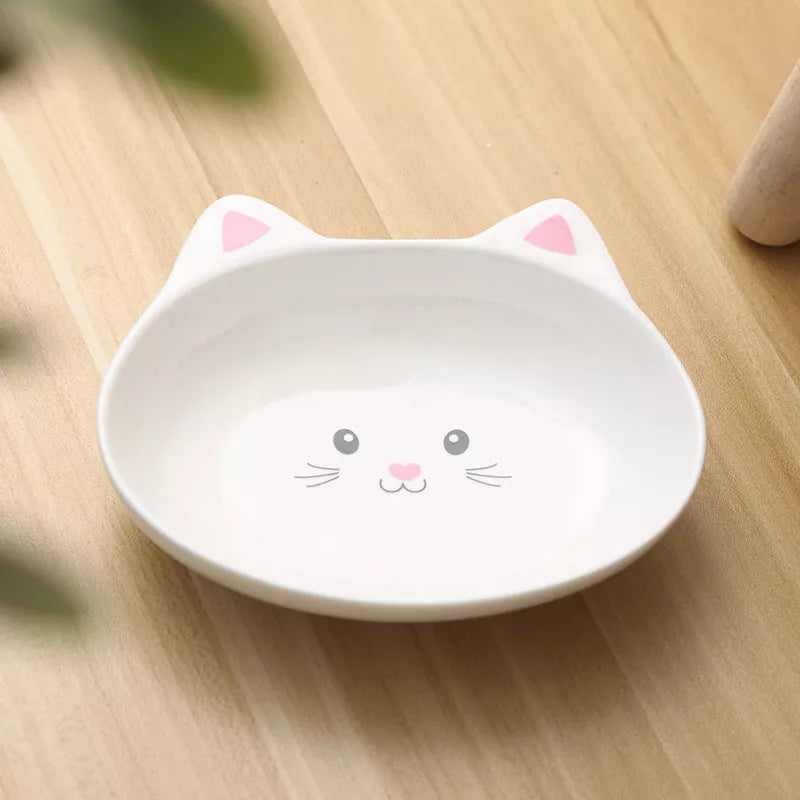 Ceramic pet food bowl with cat face design, easy to clean porcelain material