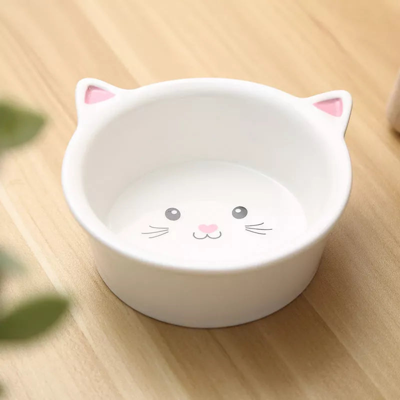 Ceramic pet food bowl with cat face design, easy to clean porcelain material