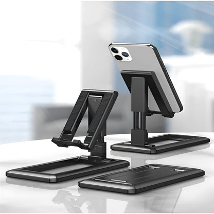 Retractable folding mobile phone stand in an adjusted position on a desktop, shown in one of four colour options.