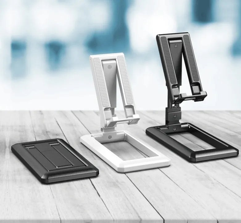Retractable folding mobile phone stand in an adjusted position on a desktop, shown in one of four colour options.