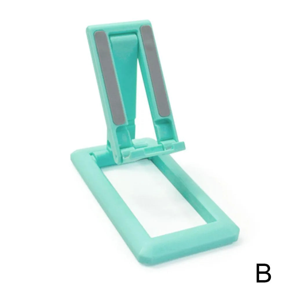 Retractable folding mobile phone stand in an adjusted position on a desktop, shown in one of four colour options.