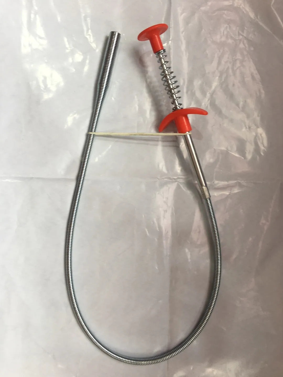 Stainless steel sewer dredge spring drain cleaning tool with a black PP handle.