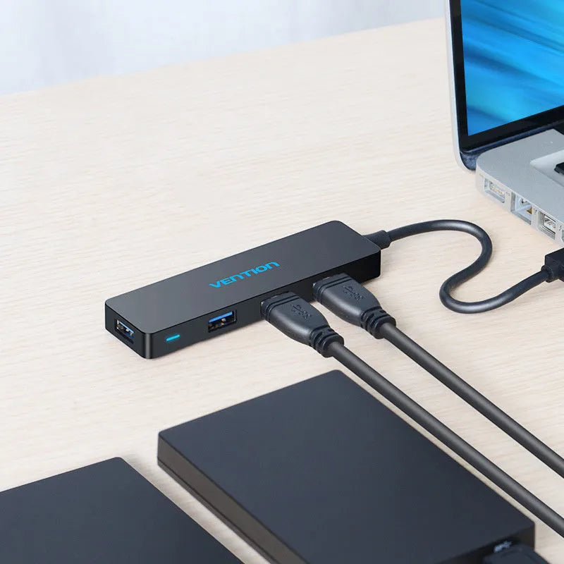 Black Wei Xun four-port USB 3.0 hub with short cable and nickel-plated interfaces