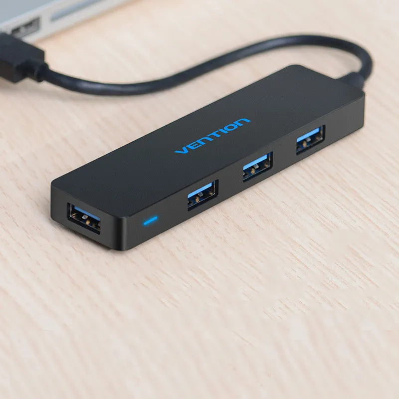 Black Wei Xun four-port USB 3.0 hub with short cable and nickel-plated interfaces